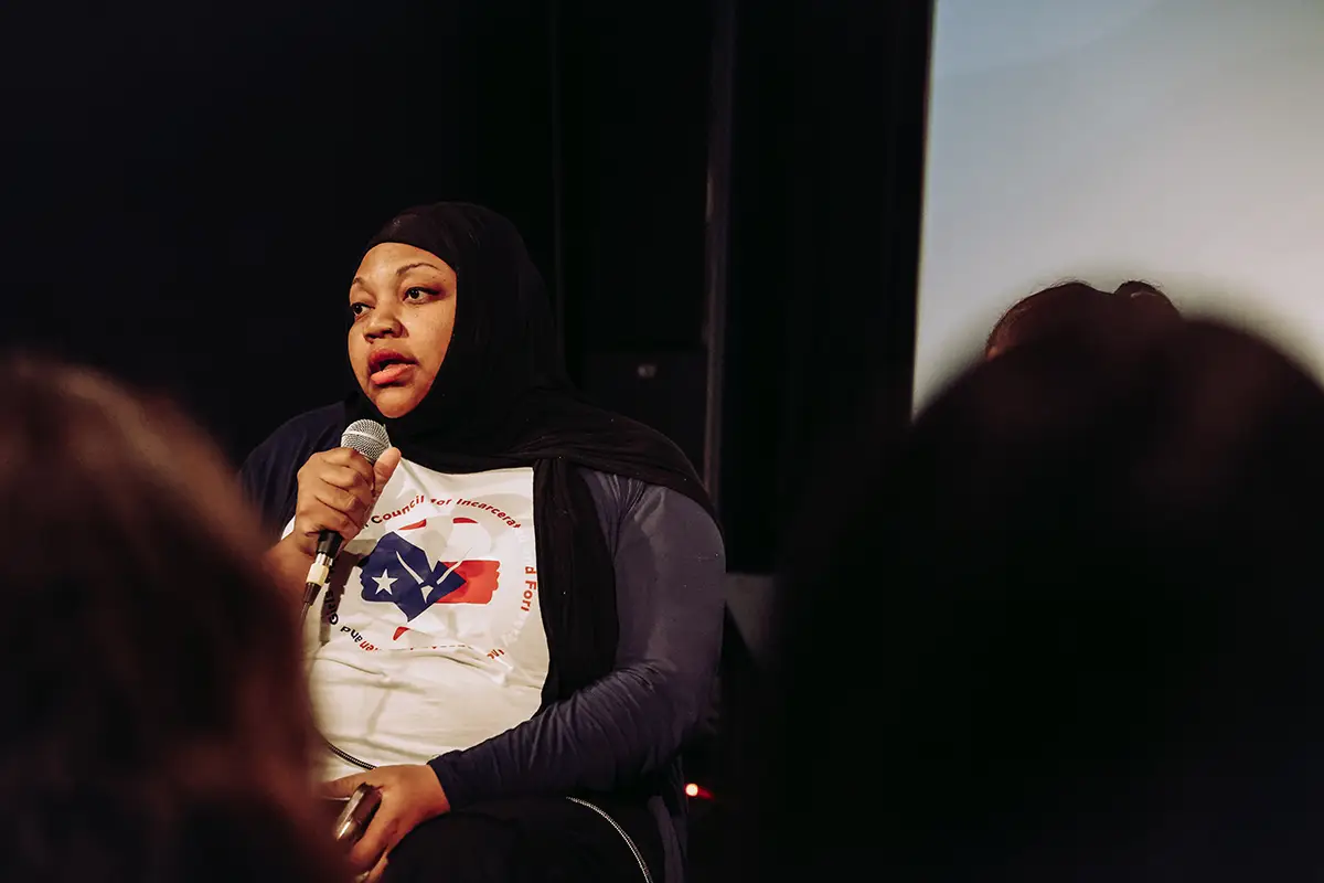 A woman speaking as part of an on-stage panel