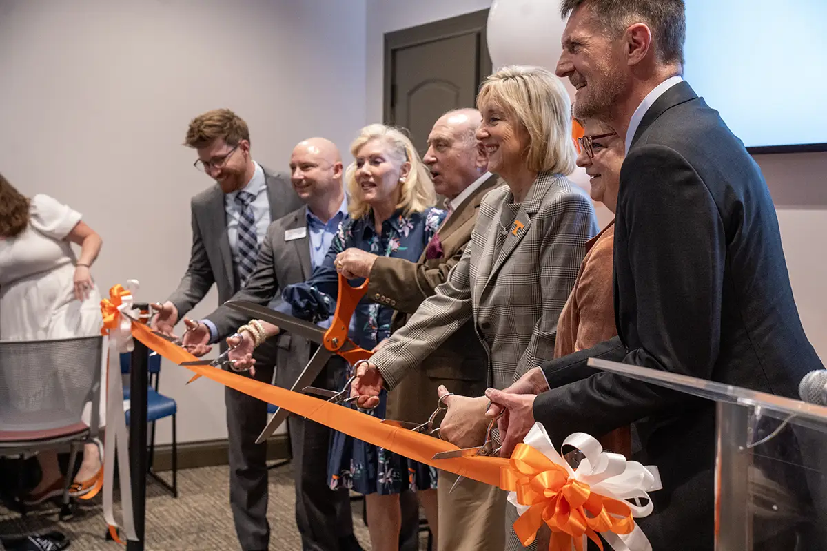 University administrators participate in a ribbon cutting