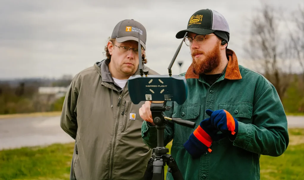 Men looking at a drone