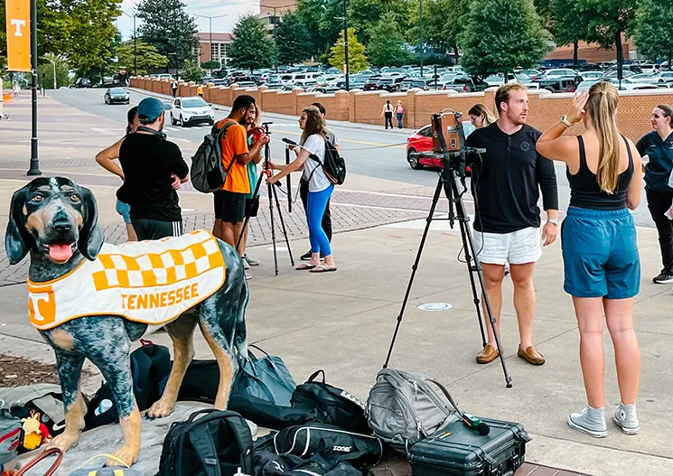 A group of people outside setting up for filming