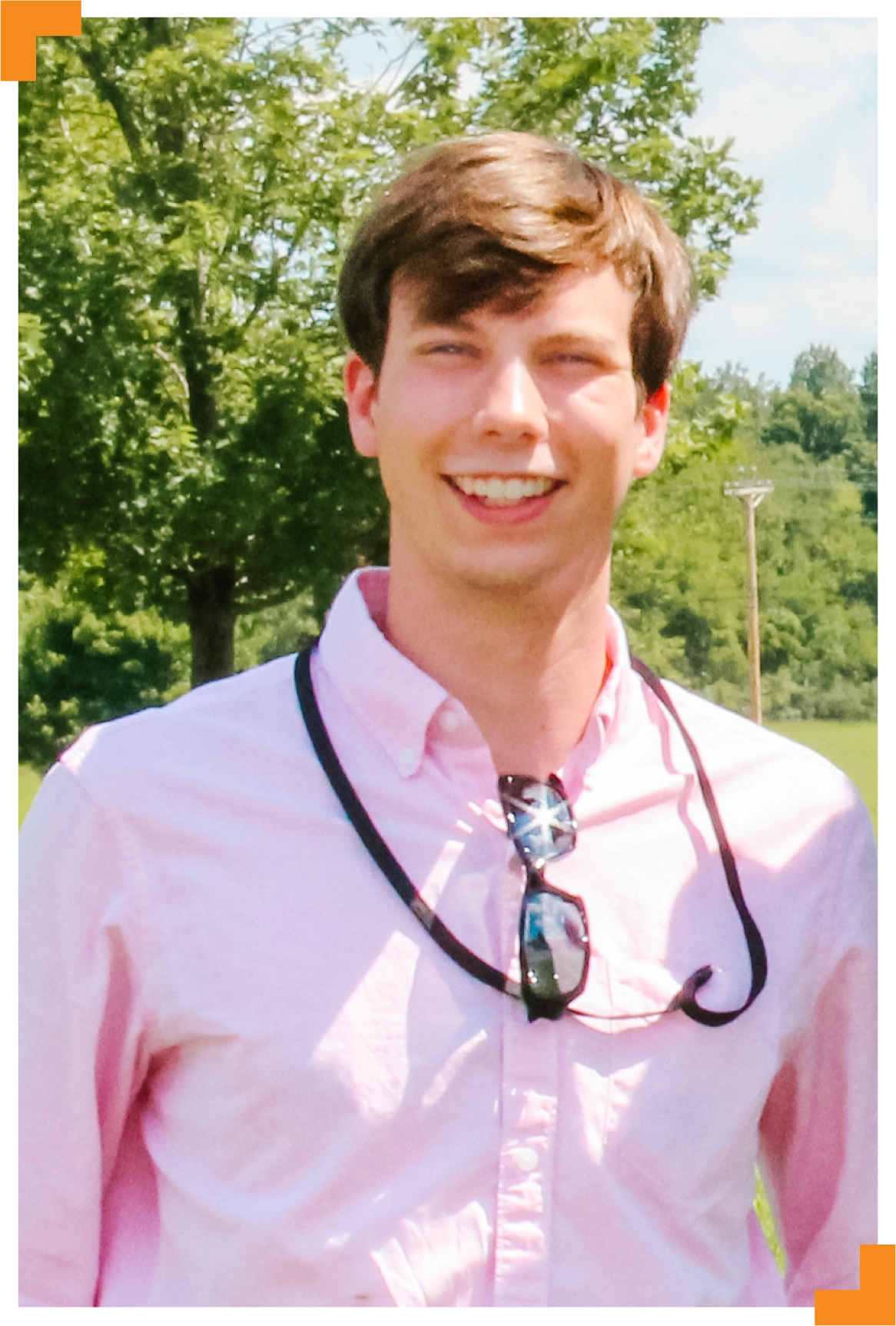 A photo of a young man surrounded by trees