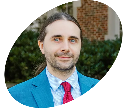 A professional headshot of a man