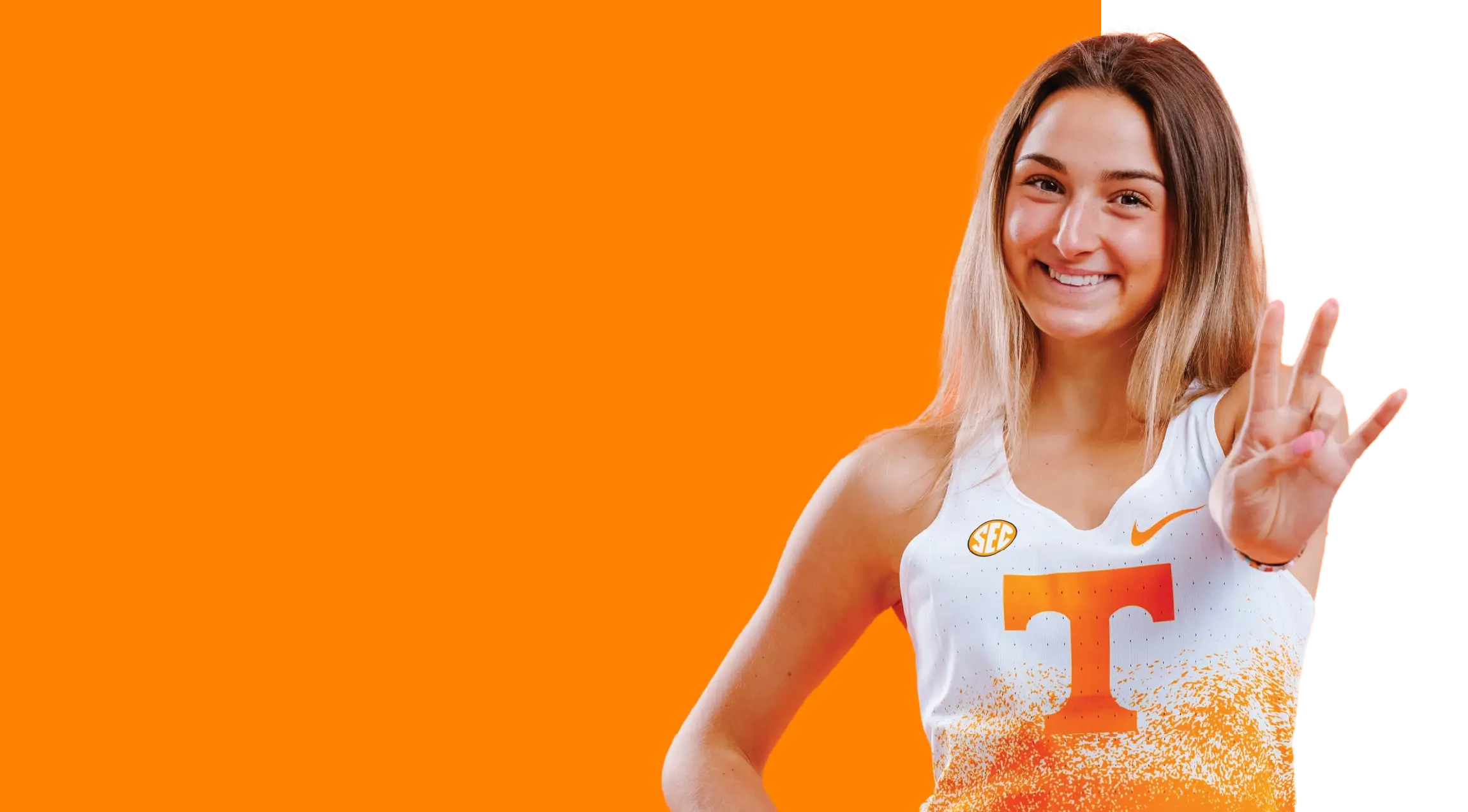 A young woman in a University of Tennessee track and field uniform set against an orange background