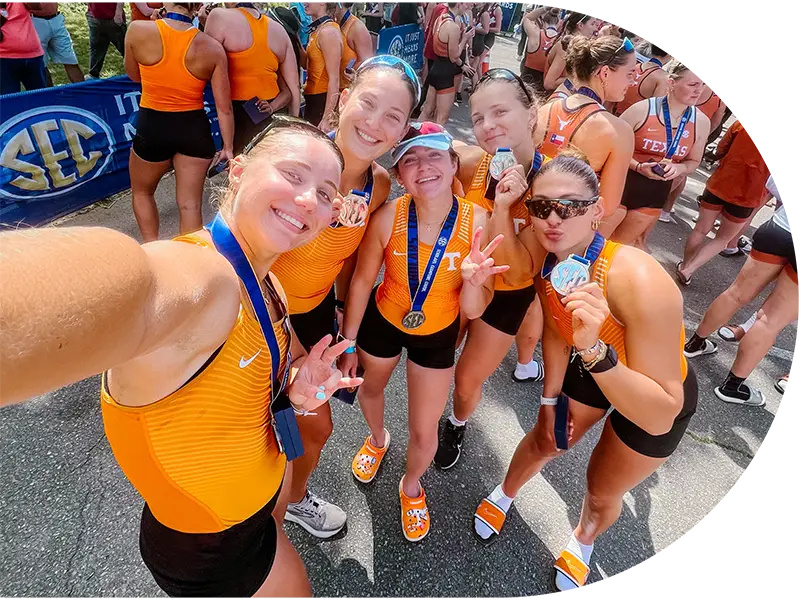 Group photo of University of Tennessee rowing athletes with their medals