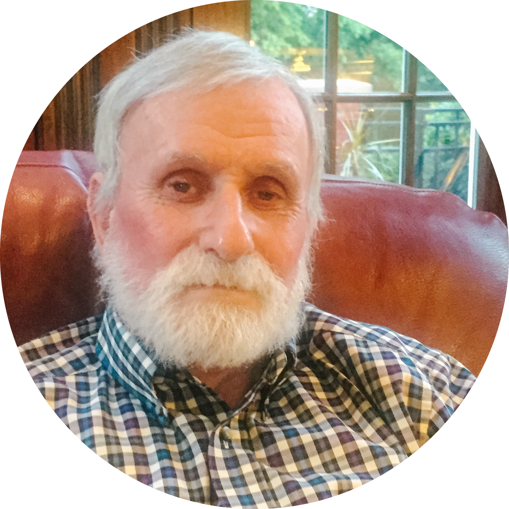 A man with a white beard sitting in a chair