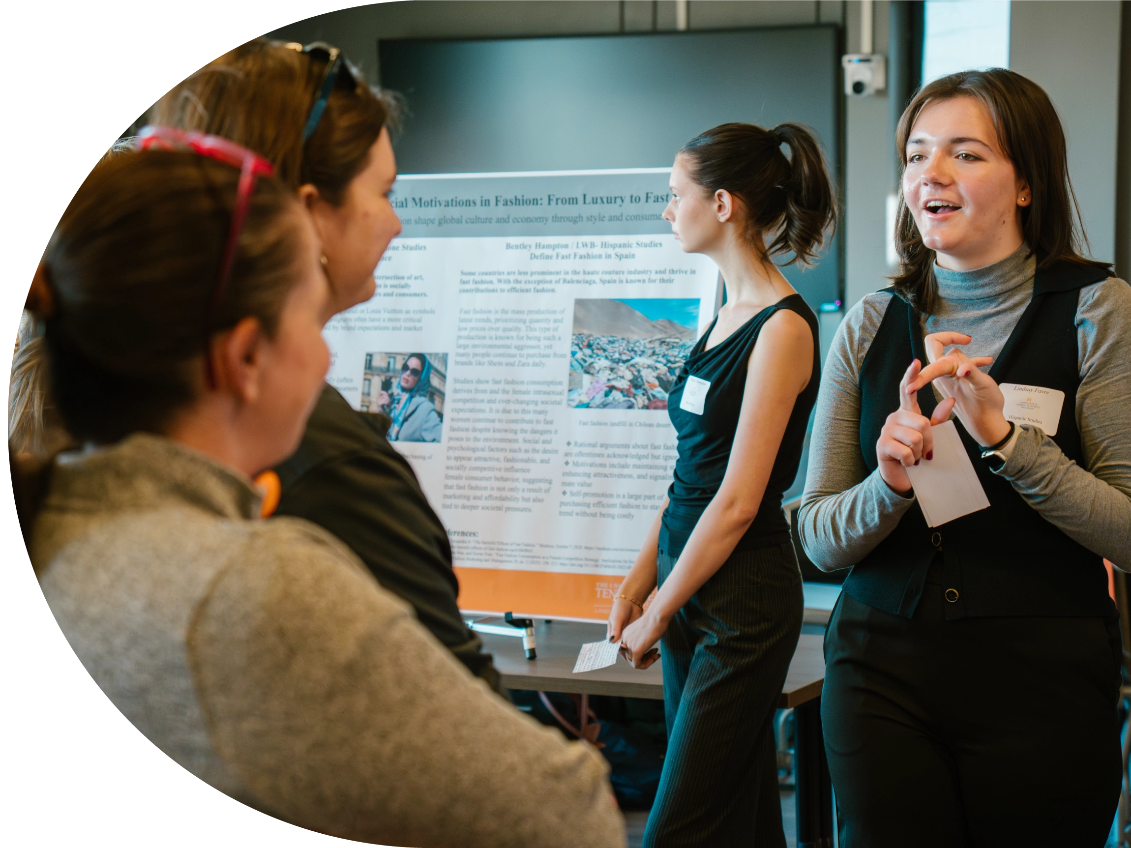 People talking at a research poster session